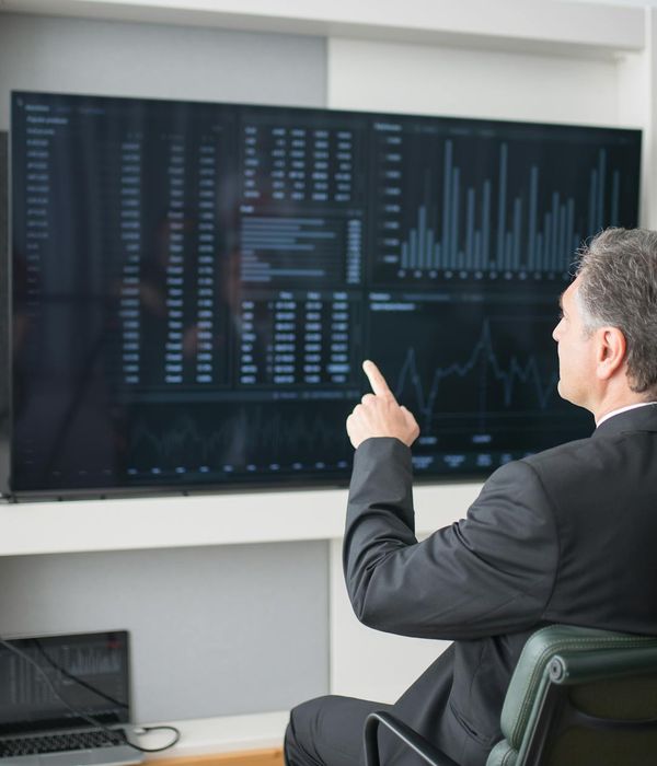 Modern office workspace with financial charts and analytics dashboard