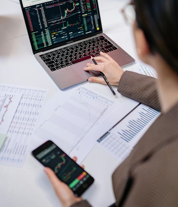 Professional financial analyst reviewing market prediction reports and charts
