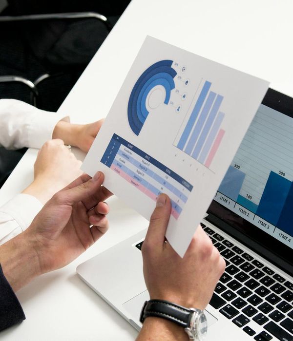 Professional team analyzing financial market data on multiple screens